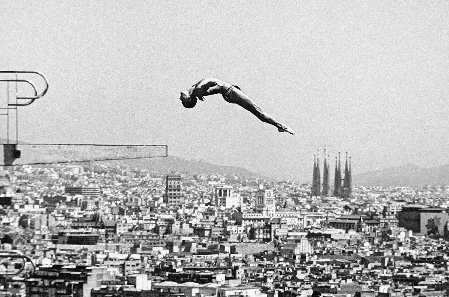 Diver jumping at Barcelona Olympics with city skyline - sports photograph by Chris Smith